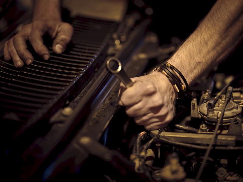 Mobile mechanic inspecting engine